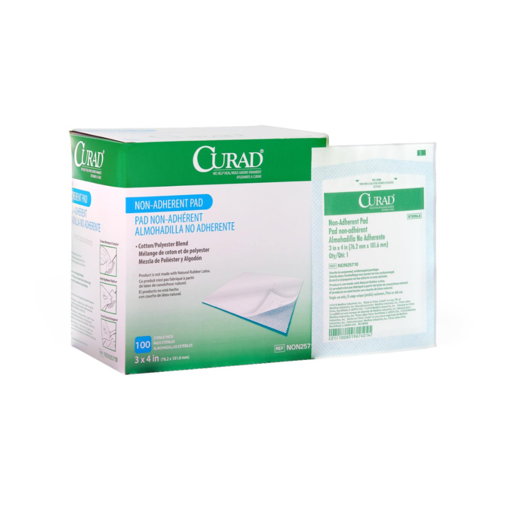A green and white box of Medline CURAD Sterile Nonadherent Dressing Pads with Spanish and English text sits beside a single wrapped pad. The box contains 100 sterile, 3x4 inch pads for wound care.